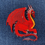Red dragon embroidered patch on denim fabric