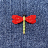 Red dragonfly patch on denim fabric
