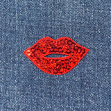 Red sequin lips patch on denim fabric