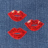 Red sequin lips on denim fabric