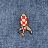Rocket-shaped patch on denim fabric