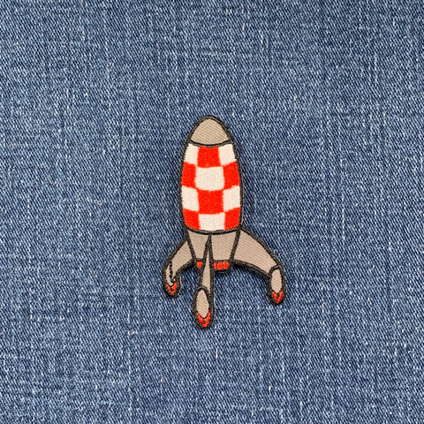 Rocket-shaped patch on denim fabric