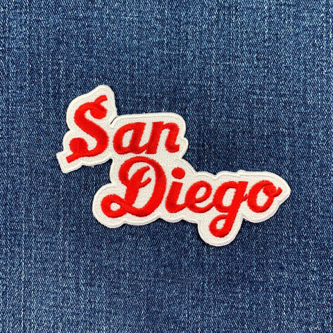 Embroidered patch with 'San Diego' text on denim fabric