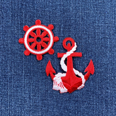 Red and white nautical wheel and anchor patches on a blue denim background