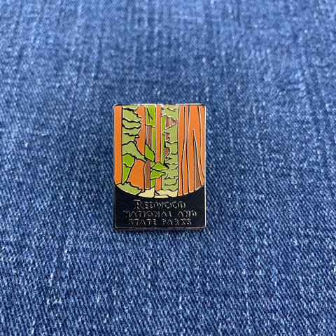 Pin with redwood national park design on a blue denim background