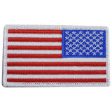A reverse patch with the design of the United States flag, intended for iron on application onto fabric on the right shoulder.