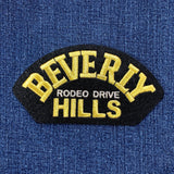 Embroidered patch with 'Beverly Hills Rodeo Drive' text on a blue fabric background