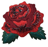 Embroidered red rose patch with green leaves on a white background