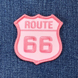 pink route 66 sign patch on a denim background