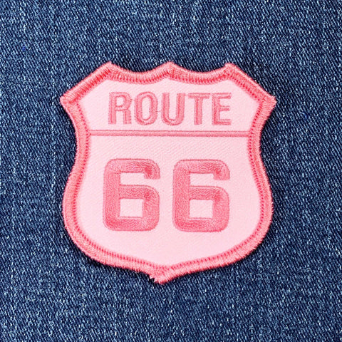 pink route 66 sign patch on a denim background