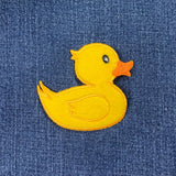 Yellow rubber duck patch on blue denim fabric
