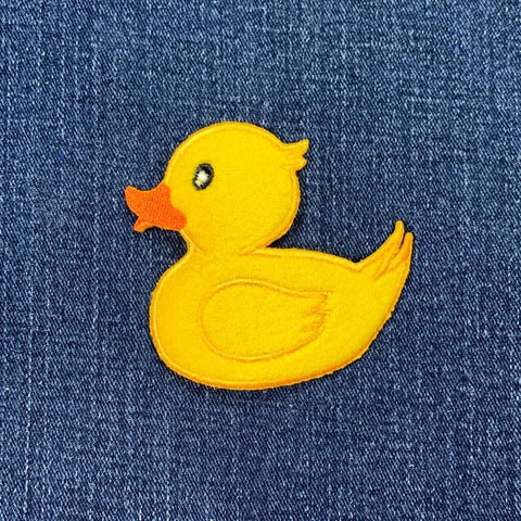 Yellow rubber duck patch on a denim background