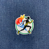 A patch featuring a running track and field motif with a silhouette of a marathon runner, a torch, and a track and on a denim background