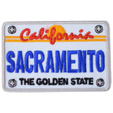 A license plate patch depicting the text 'California' and 'SACRAMENTO' with a stylized 'Golden State' motif in orange and blue on a white background.