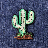 Embroidered cactus patch on a denim background