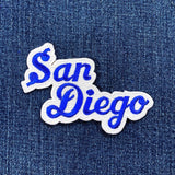 Embroidered patch with 'San Diego' text on denim fabric