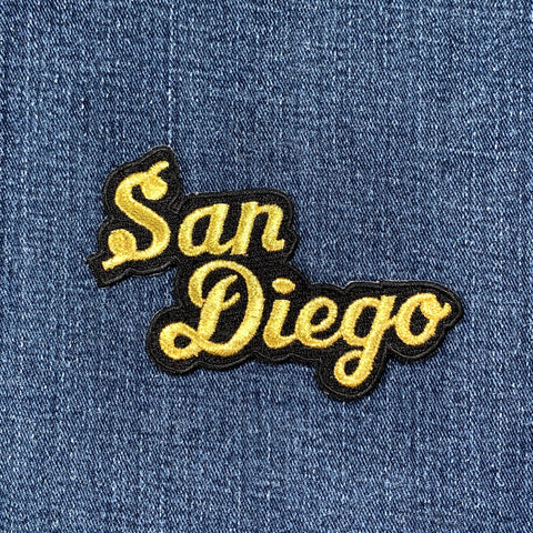 Embroidered patch with 'San Diego' text on denim fabric