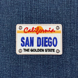 Embroidered patch of a California license plate with 'San Diego' on denim fabric