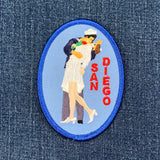 embroidered patch of Unconditional Surrender statue also known as the kissing statue with 'San Diego' text on a blue background 