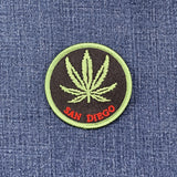 Patch with a cannabis leaf and 'San Diego' text on denim fabric
