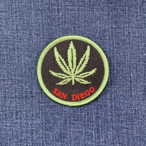 Patch with a cannabis leaf and 'San Diego' text on denim fabric