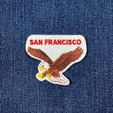 Embroidered patch with an eagle and 'San Francisco' text on denim fabric