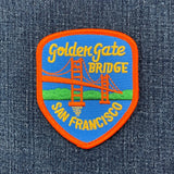 A shield-shaped embroidered patch features the Golden Gate Bridge in orange, with "Golden Gate BRIDGE" and "SAN FRANCISCO" text.