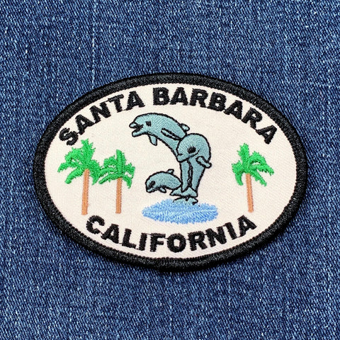 Embroidered patch with 'Santa Barbara, California' text and dolphins on a denim background
