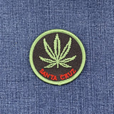 Embroidered patch with a cannabis leaf and 'Santa Cruz' text on denim fabric