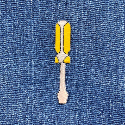 Screwdriver-shaped patch on denim fabric