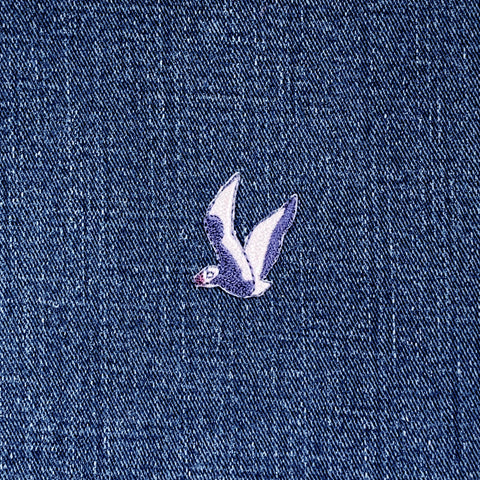 Small seagull patch on a denim fabric background