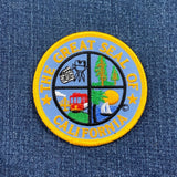A patch depicting California attractions including San Francisco Golden Gate Bridge and Hollywood movie sets, on a denim background.