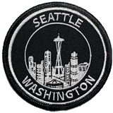 A black and white patch featuring the Seattle skyline with the text 'Seattle WA' and a badge design.