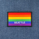 Rainbow flag patch with 'Seattle' text on a denim background
