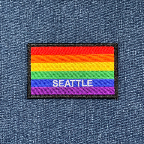 Rainbow flag patch with 'Seattle' text on a denim background