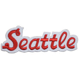 An embroidered patch featuring the word 'Seattle' in red cursive lettering with a white border, shown on a plain white background.