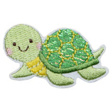 Embroidered patch of a green turtle with a smiling face on a white background