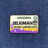 Embroidered patch with Seligman, Arizona design on denim fabric