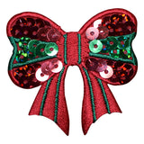 A red embroidered bow embellished with green and pink sequins, isolated on a white background.