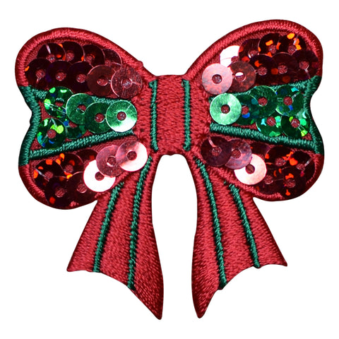 A red embroidered bow embellished with green and pink sequins, isolated on a white background.