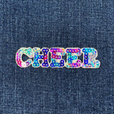 A sequin cheerleading badge patch spelling out the word 'CHEER' with multicolored sequins on a denim background.