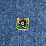embroidered and sequined turntable  patch on a denim background