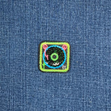 Colorful patch with a record player design on a denim background