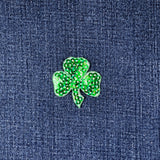 Green shamrock patch on blue denim fabric