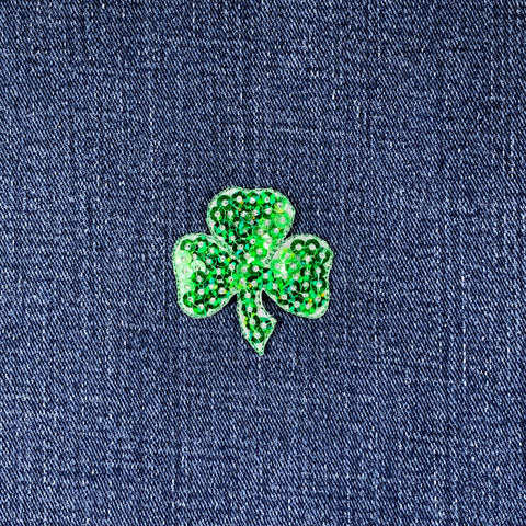 Green shamrock patch on blue denim fabric