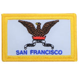 An embroidered patch featuring a golden eagle with a red and blue banner, and the text 'SAN FRANCISCO' below it.