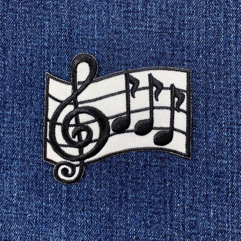 Music notes and treble clef patch on denim fabric