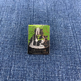 A collectible pin featuring an illustration of a waterfall with the text 'Shenandoah National Park' at the bottom on a denim background