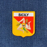 Embroidered patch with 'Sicily' text on a denim background