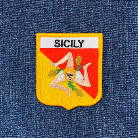 Embroidered patch with 'Sicily' text on a denim background